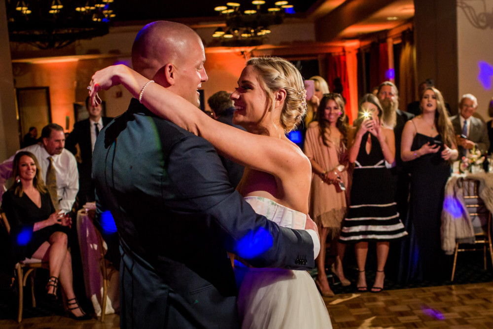 Bride laughs during the first dance at their wedding reception