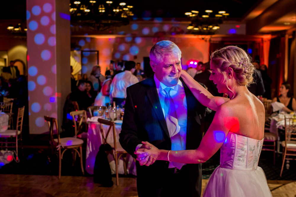 Bride and father laugh during the father daughter dance