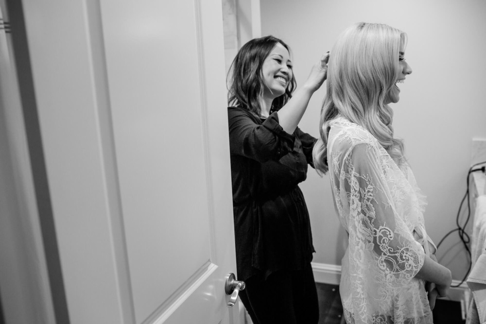 Bride having her hair done and laughing