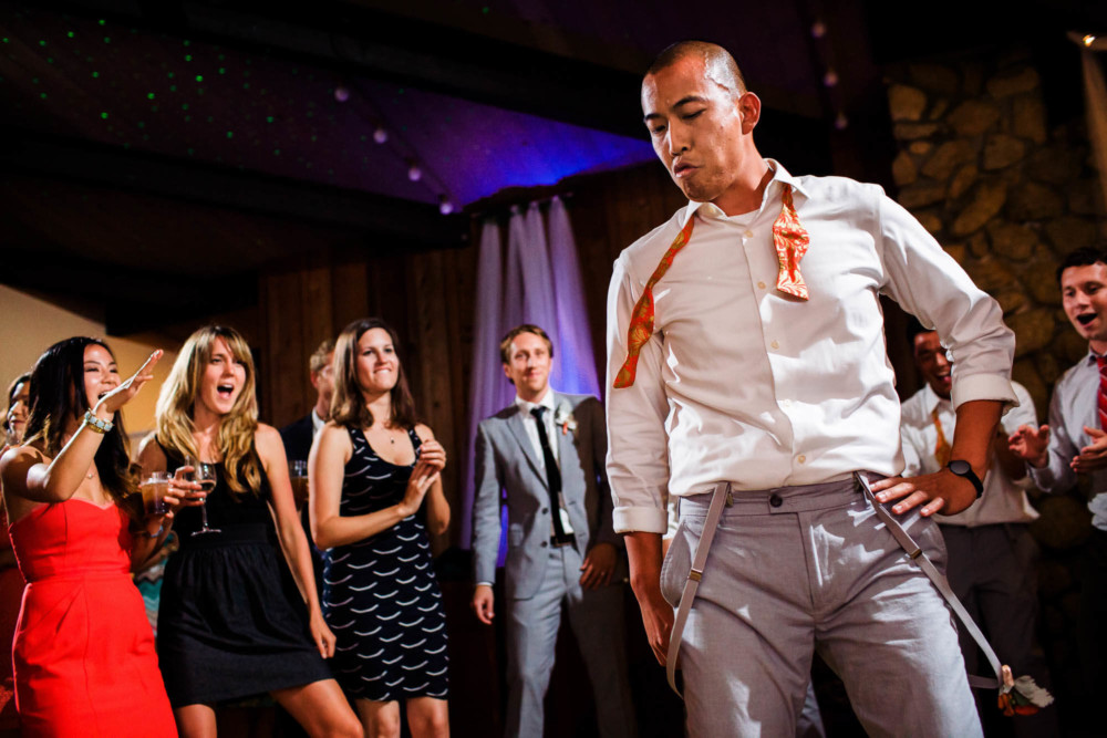 Guests dancing at a colorful wedding reception at the Sequoia Retreat Center in Ben Lomond