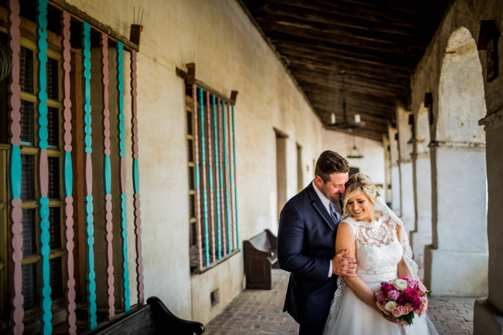 Portrait of a bride and groom outside mission San Miguel