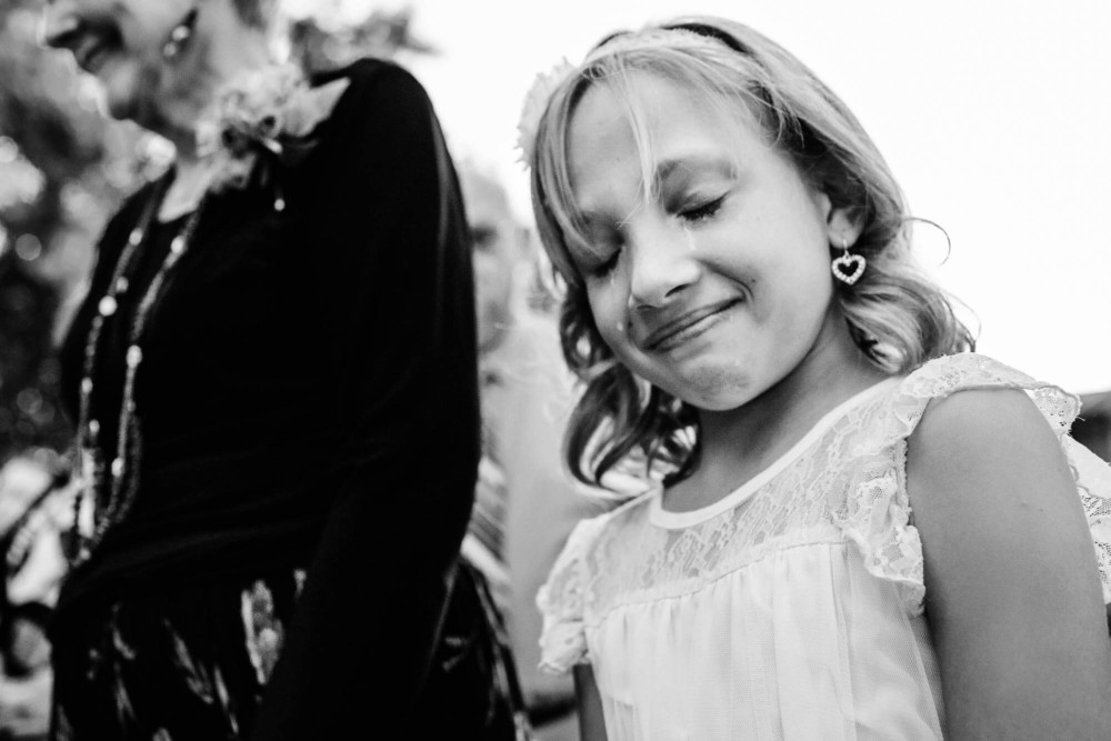 flower girl happy cries during the wedding ceremony