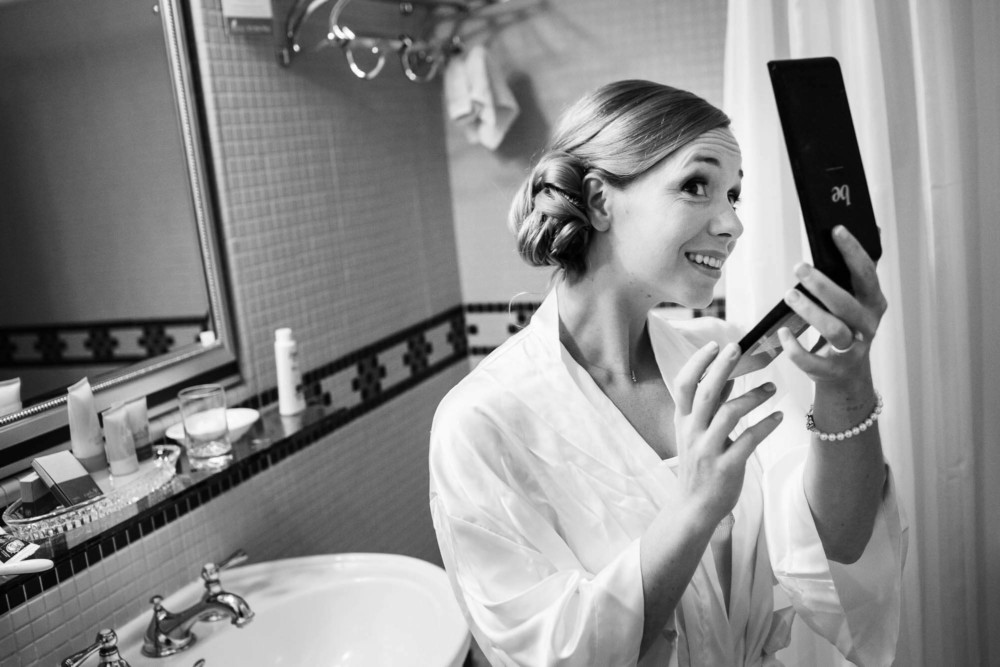 Bride checks out her hairstyle in the mirror in her room at the Majestic Yosemite Hotel