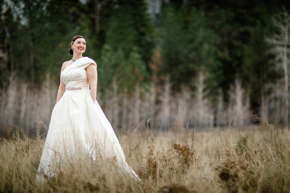 Bride poses with her dress and pockets in El Capitan Meadow in Yosemite Valley