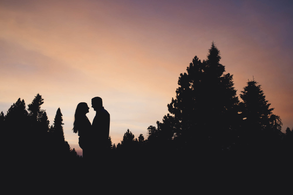 Silhouette of a couple in the mountains at sunset in the Sierra Nevada mountains.