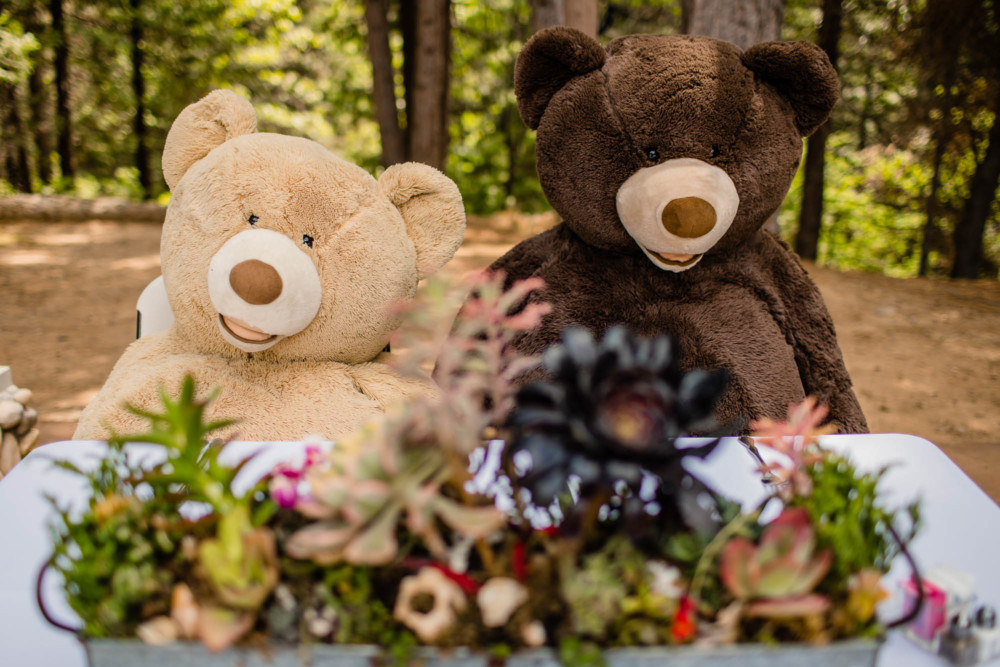 Giant teddy bears sitting at a sweetheart table at a wedding