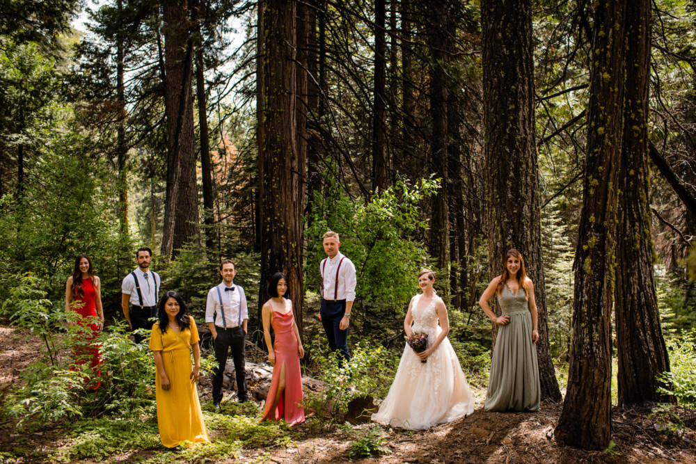 Bride and her bridesmaids and men in multicolored dresses and bolo ties