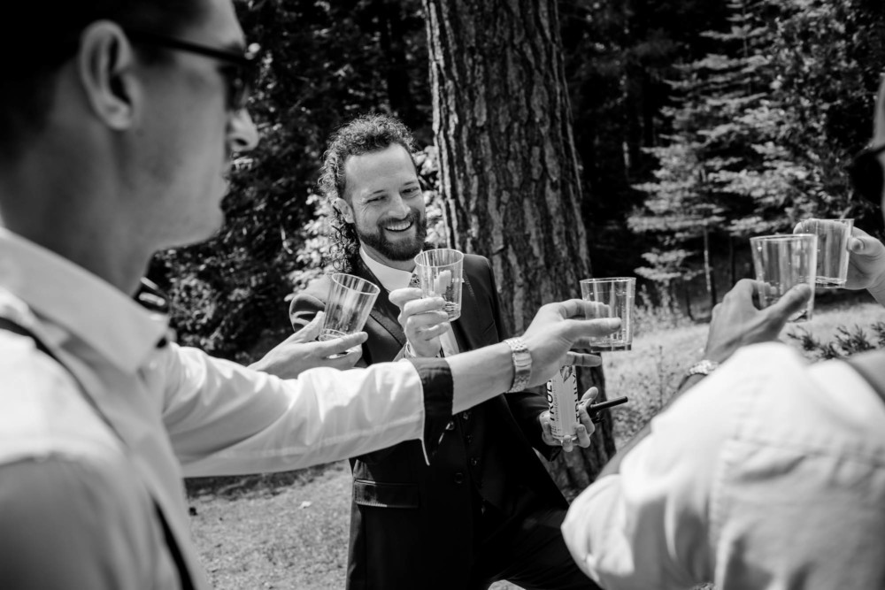 Groom toasting bourbon with his groomsmen
