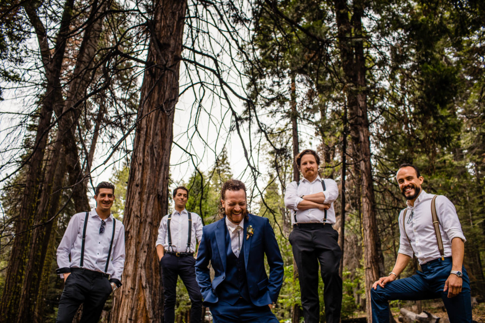 Groom laughs during a portrait of him and his groomsmen