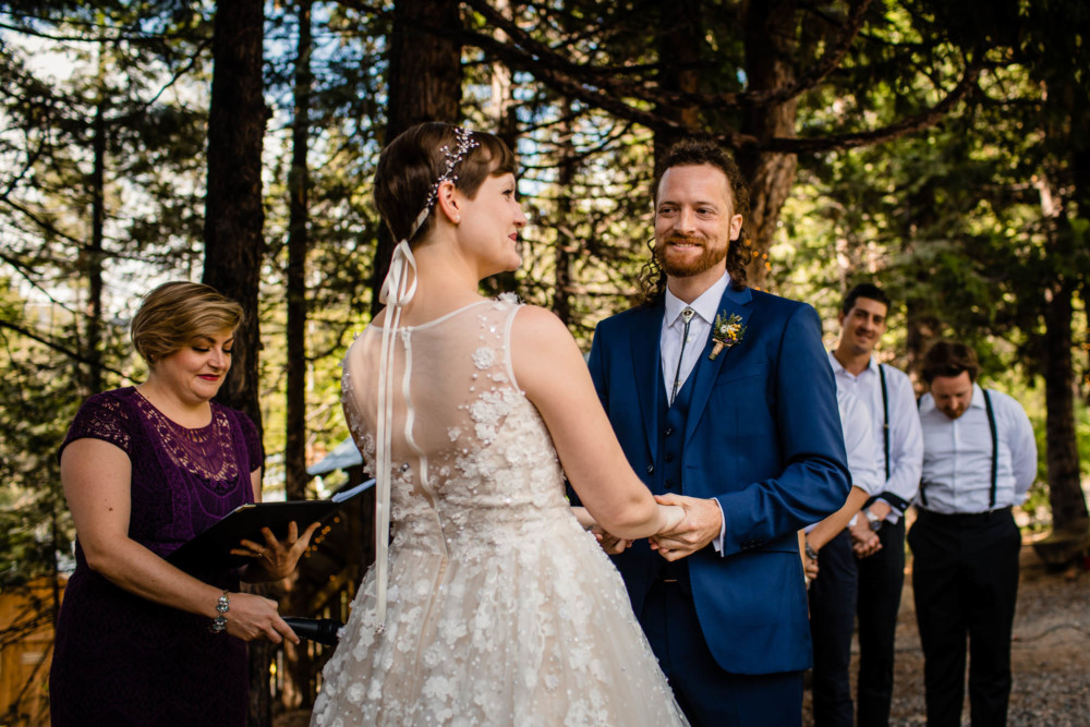 Groom smiles at his bride during the wedding ceremony at Paradise Springs near Yosemite National Park