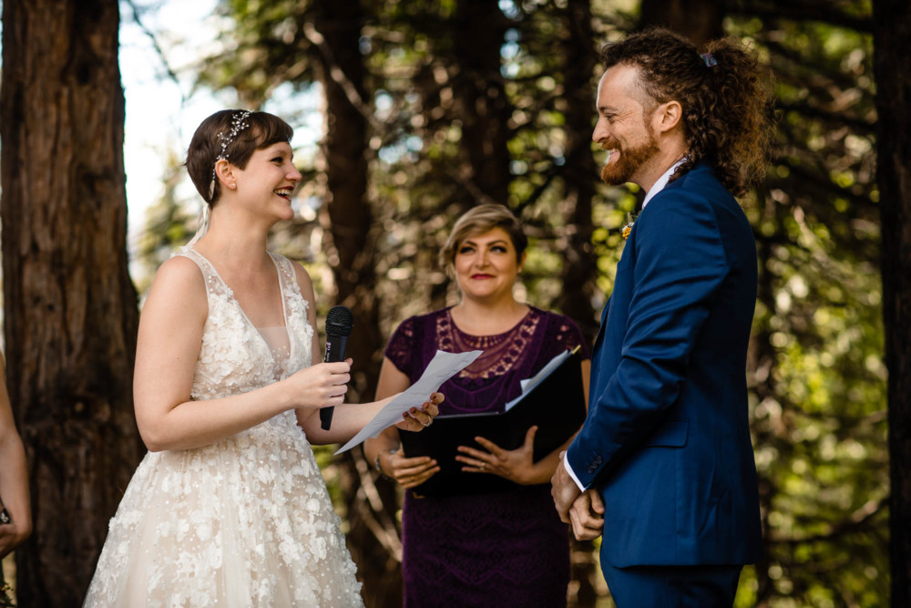 Groom laughs at a joke told by the bride in her wedding vows near Yosemite