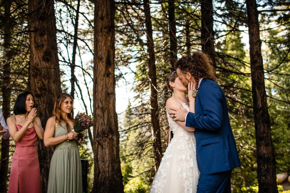 Bride and groom kiss following their ceremony in the forest at Paradise Springs near Yosemite National Park