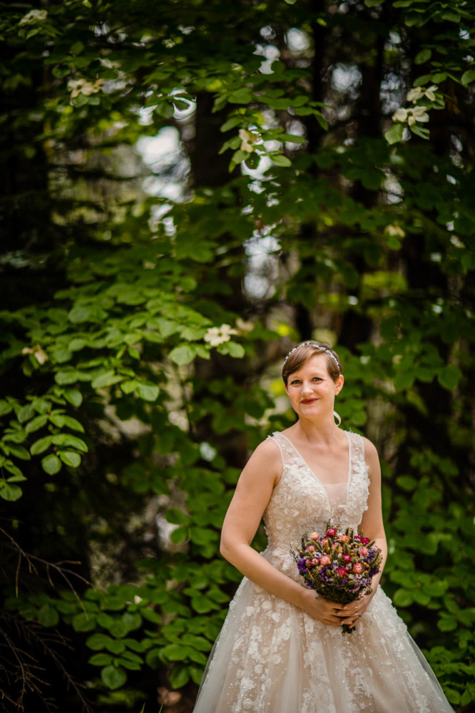 Portrait of a bride in front of blooming dogwood trees.