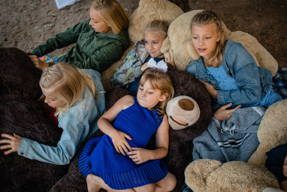 Cuddle Puddle with a bunch of kids and a pile of giant teddy bears