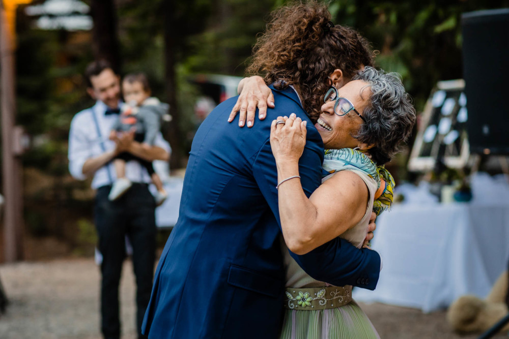 Mother hugs her son, the groom, after their dance