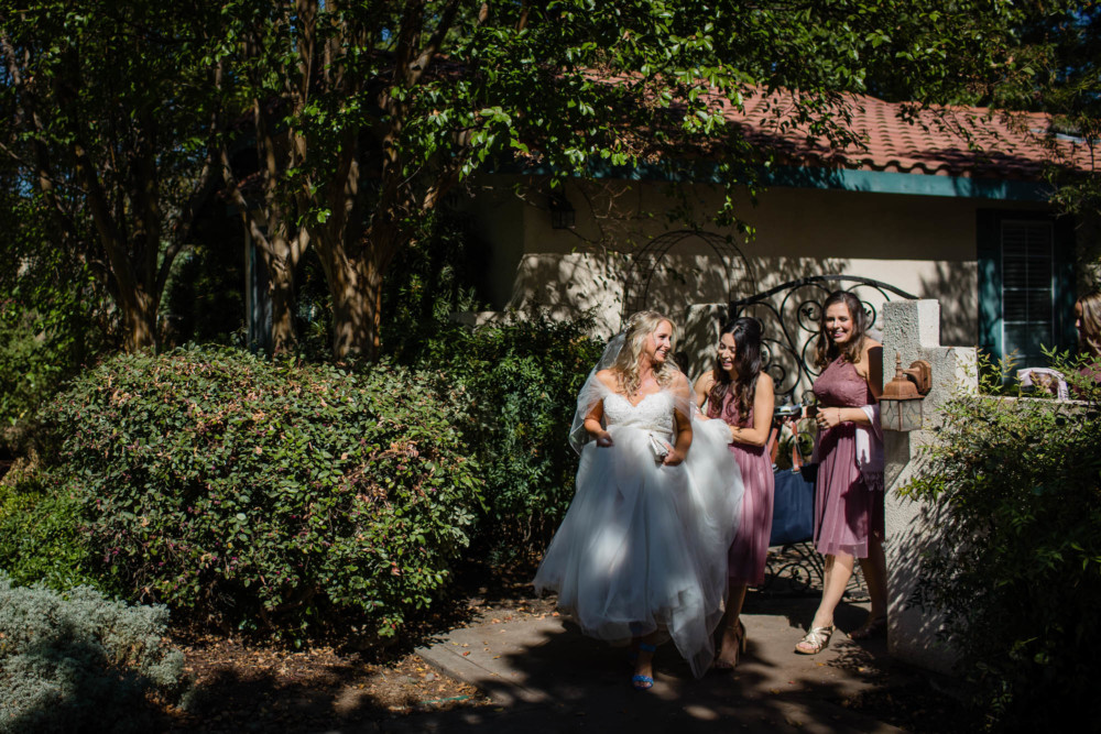 Bride leaves her home with her bridesmaids before her wedding ceremony in Fresno, CA