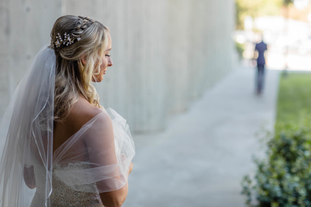 Bride waits behind as the groom walks away