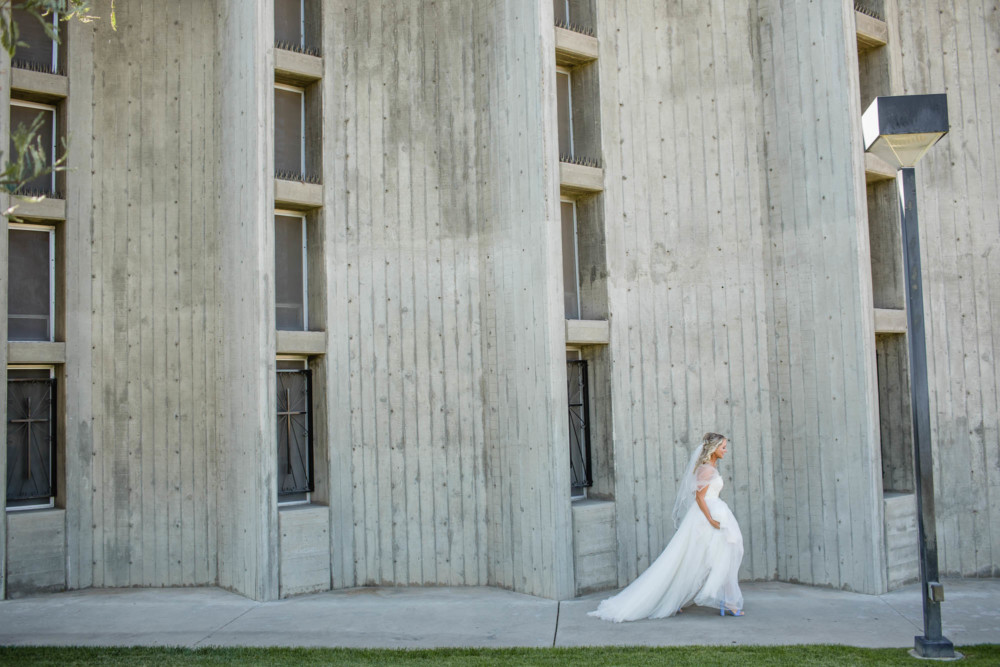Bride walks outside St Anthony's before her wedding ceremony