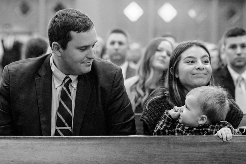 Little baby mad dogs his dad in the pews at St Anthony's church