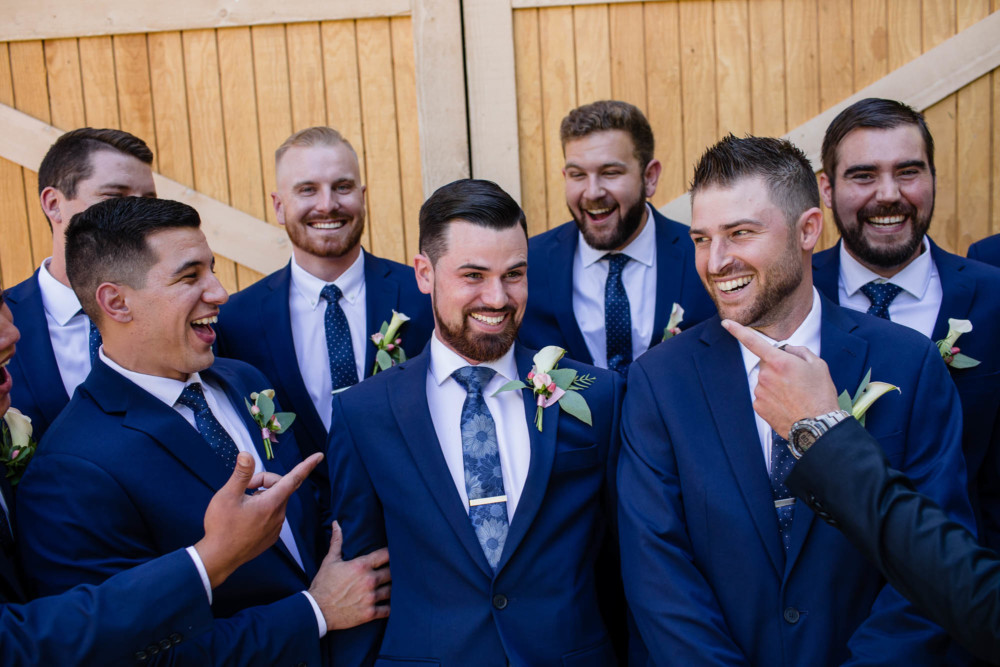 groomsmen being funny with the groom