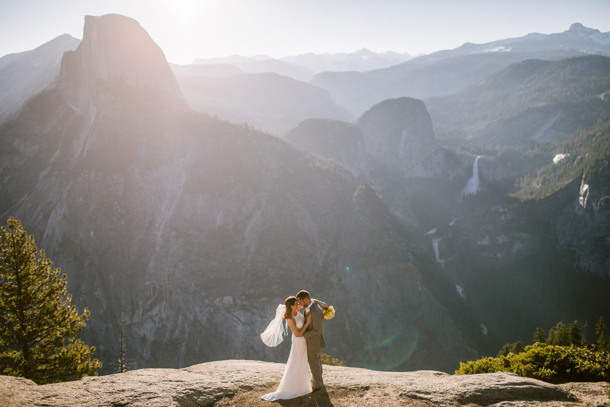 Wedding couple at sunrise at Glacier Point with Half Dome, Vernal Falls, and Nevada Falls Below