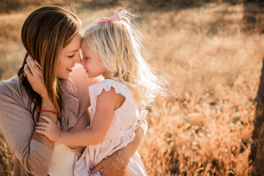 Mother and daughter portrait in a golden foothill hillside