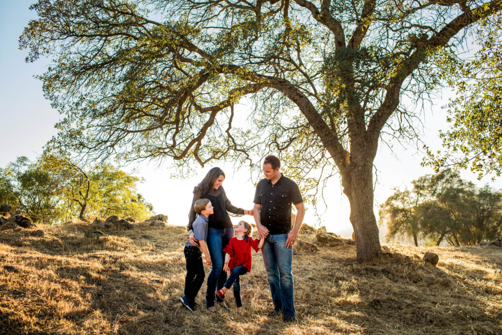 Informal family portrait under a large oak tree in the Sierra Foothills